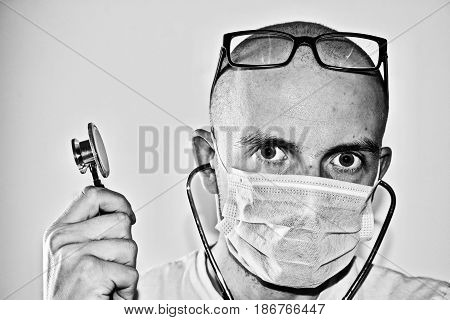 Young man doctor with a stetoscope in hand