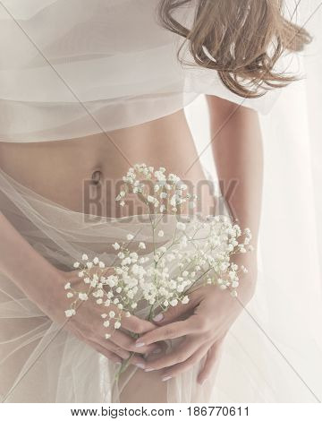 Cute girl in white lingerie. Sensual photo. Man is unrecognizable