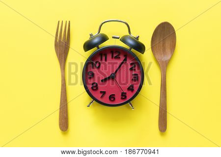Food clock. Healthy food concept on yellow background