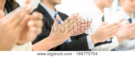 Group of business people clapping their hands at the meeting panoramic banner