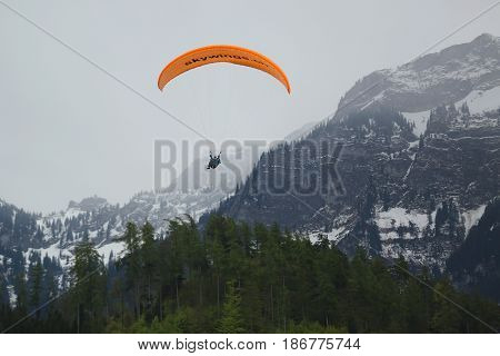 INTERLAKEN, SWITZERLAND - MAY 4, 2017: Tandem paragliding flights over the Swiss Alps in Interlaken, Switzerland
