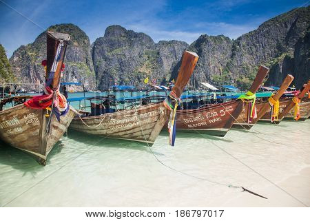 KO PHI PHI LEH, THAILAND, February 1, 2014: Traditional long tail boats on the beach of Maya Bay, Andaman Sea, famous tourist destination in the Ko Phi Phi achipelago