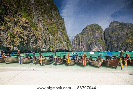 KO PHI PHI LEH, THAILAND, February 1, 2014: Traditional long tail boats on the beach of Maya Bay, Andaman Sea, famous tourist destination in the Ko Phi Phi achipelago