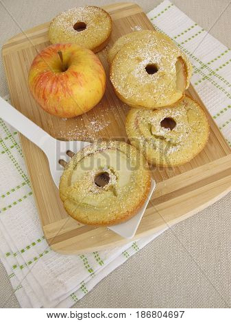 Oven baked apple donuts and a fresh apple