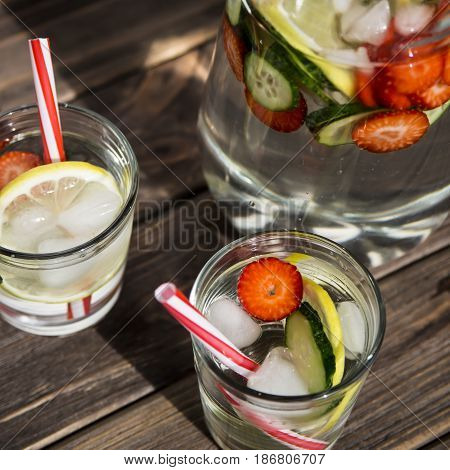Water withfresh  lemon strawberries and cucumber