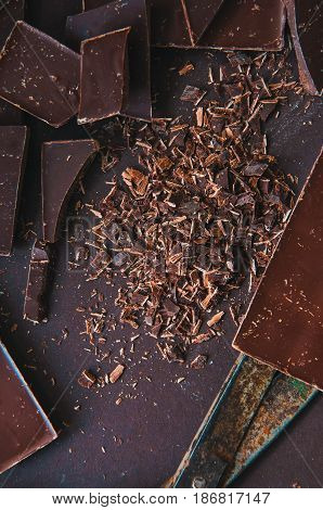 Whole And Pieces Of Dark Chocolate Bars On A Darkbackground  At Monochrome Setting. Top View.toned.
