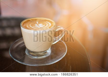 Coffee cup on black metal table in coffee shop