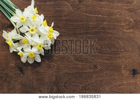 ..daffodils Lie On A Wooden Background
