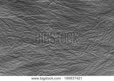 Black crumpled sheet of paper. Grungy background texture with copy space for text or image.