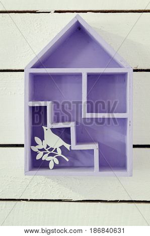 House interior decoration using little wooden levender house with bird on white background.
