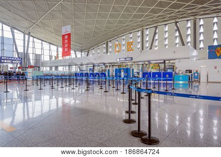 Urumqi China October 28 2016: The public check-in area with crowd control barriers of the city airport at early morning time.