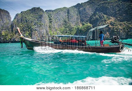 KO PHI PHI LEH, THAILAND, February 1, 2014: Traditional long tail boats on the beach of Maya Bay, Andaman Sea, famous tourist destination in the Ko Phi Phi achipelago