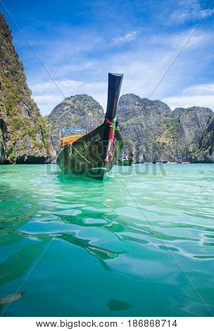 KO PHI PHI LEH, THAILAND, February 1, 2014: Traditional long tail boats on the beach of Maya Bay, Andaman Sea, famous tourist destination in the Ko Phi Phi achipelago