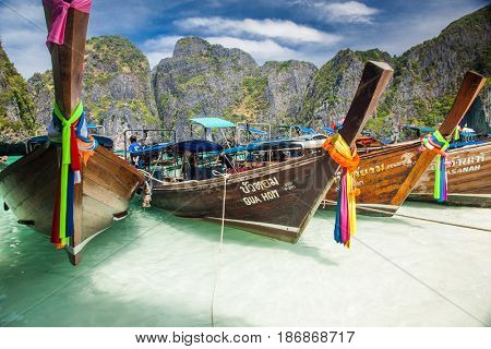 KO PHI PHI LEH, THAILAND, February 1, 2014: Traditional long tail boats on the beach of Maya Bay, Andaman Sea, famous tourist destination in the Ko Phi Phi achipelago
