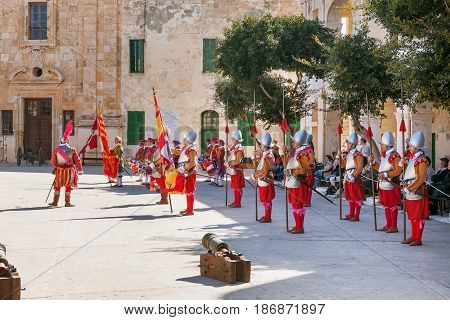 VALLETTA MALTA - February 21 2010 - Knights of the Order of St. John during reenactment. Tourists watch the performance from from the fenced places.