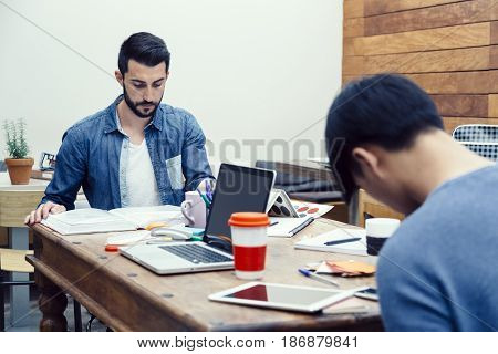 Two young entrepreneurs preparing their new business project in a modern coworking espace