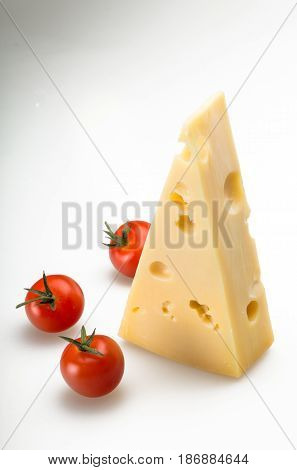 Cheese cheese piece cheese wedge emmental cheese swiss cheese slice cherry tomatoes