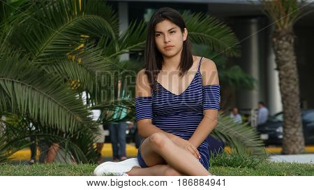 Unhappy And Serious Person Sitting on Grass