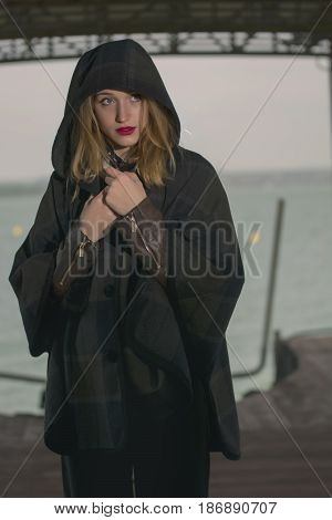 Young girl posing on pier at Lake Siutghiol