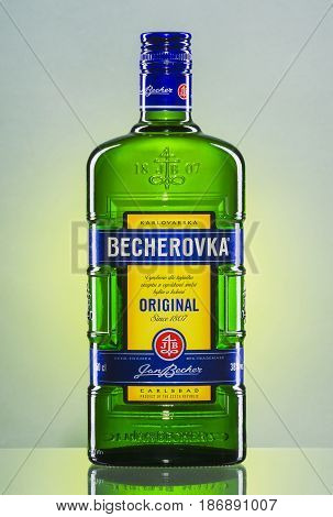Bottle of Becherovka on gradient background. Becherovka is herbal bitters produced in Karlovy Vary in Czech Republic by Jan Becher company since 1807