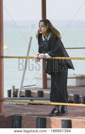 Young girl posing on pier at Lake Siutghiol