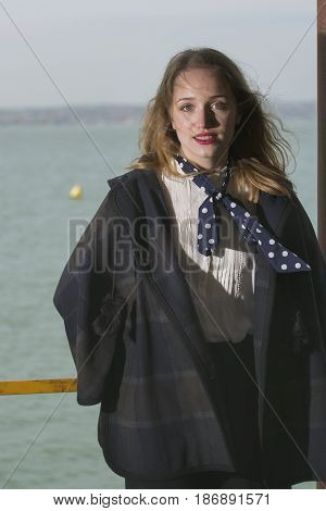 Young girl posing on pier at Lake Siutghiol