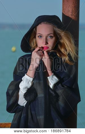Young girl posing on pier at Lake Siutghiol