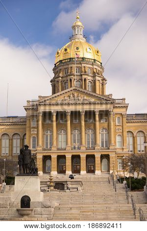 The US and State flags fly at the Des Moines Capital Building