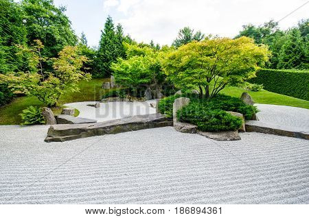 japanese zen garden with trees in the background
