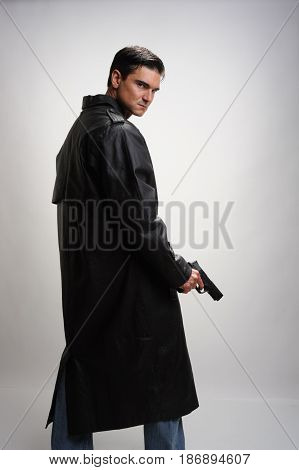 The sinister warrior is holding on to a pistol.
