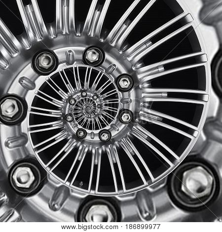 Car automobile wheel rim spiral abstract metallic fractal background. Silver hex nuts, wheel spokes spiral effect pattern background illustration. Automotive abstract wheel. Truck chrome wheel rim