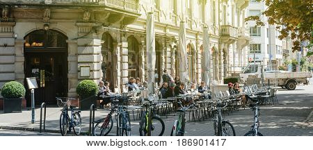 STRASBOURG FRANCE - APR 23 2017: French people and tourists anjyin a cafe and a dessert outside terrace Brant cafe in Strasbourg France