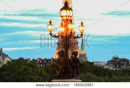Paris France-May 15 2017 :The street lantern on the Alexandre III Bridge and Eiffel tower in the background Paris France.