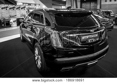 STUTTGART GERMANY - MARCH 03 2017: Mid-size luxury crossover SUV Cadillac XT5 Platinum 2017. Rear view. Black and white. Europe's greatest classic car exhibition 