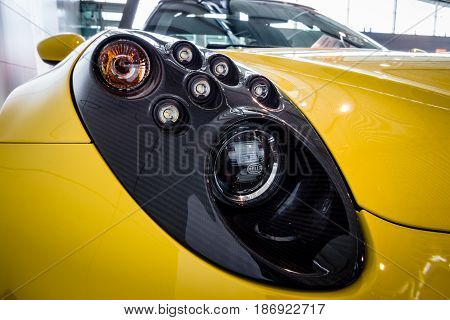 STUTTGART GERMANY - MARCH 03 2017: Headline of the sports car Alfa Romeo 4C Spider (Type 960) 2015. Close-up. Europe's greatest classic car exhibition 