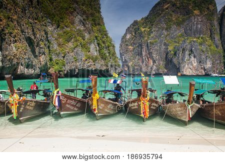 KO PHI PHI LEH, THAILAND, February 1, 2014: Traditional long tail boats on the beach of Maya Bay, Andaman Sea, famous tourist destination in the Ko Phi Phi achipelago