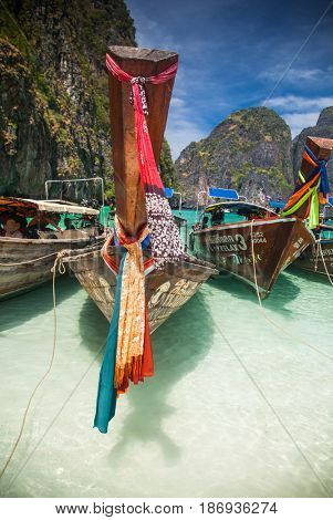 KO PHI PHI LEH, THAILAND, February 1, 2014: Traditional long tail boats on the beach of Maya Bay, Andaman Sea, famous tourist destination in the Ko Phi Phi achipelago