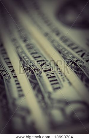 Peníze background - pozadí amerických dolarů. Zblízka, ve stylu retro tónovaný fotografie s mělkým DOF a s