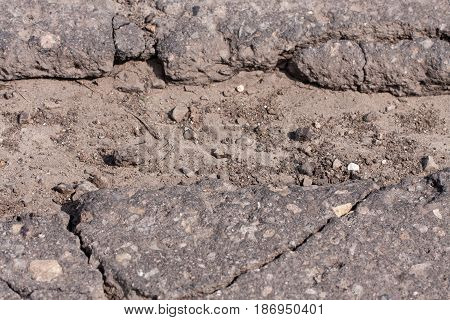 large pit with stones on the asphalt highway.