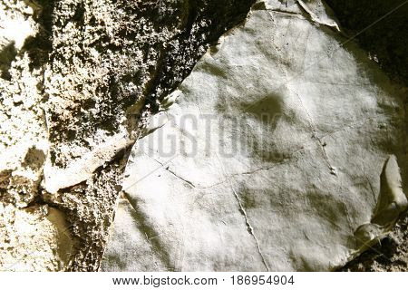 spotlight and shadow against the stone wall 1