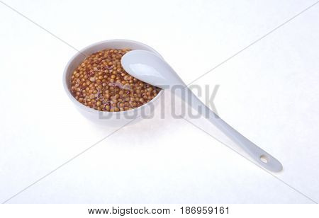 Typical french dijon rough mustard in bowl from isolated on white background.