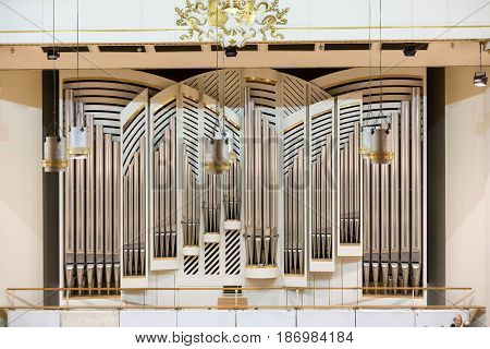 CRACOW POLAND - SEPTEMBER 25 2015: View of the stage of the concert hall at the Cracow Philharmonic with the new Orgelbau organ in the background. Cracow Poland
