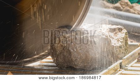 Man Cutting A Stone With A Water Saw