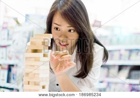 Asian Lady Play Jenga Game