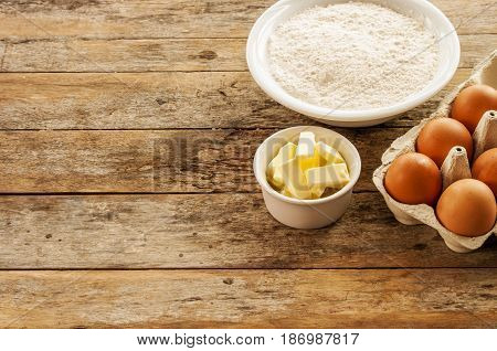 baking ingredients egg flour and butter close up