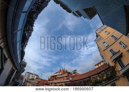Milan (Lombardy italy): old typical residential buildings along via Piero della Francesca with dramatic sky. Fisheye lens.