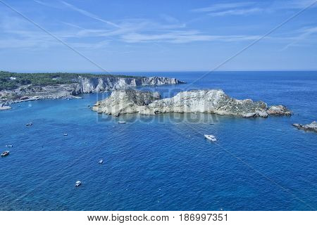 Tremiti islands with blue water boats and clouds