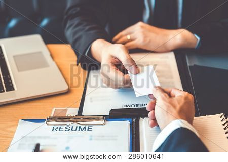 Employee Young Man Exchanging A Business Card To Senior Manager During Job Interview Concept