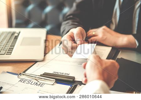 Employee Young Man Exchanging A Business Card To Senior Manager During Job Interview Concept