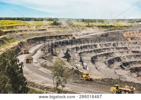 Large Quarry Dump Truck. Loading The Rock In Dumper. Loading Coal Into Body Truck. Production Useful